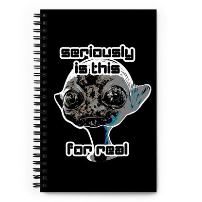 a spiral bound notebook with cover an alien and text "seriously is this for real"