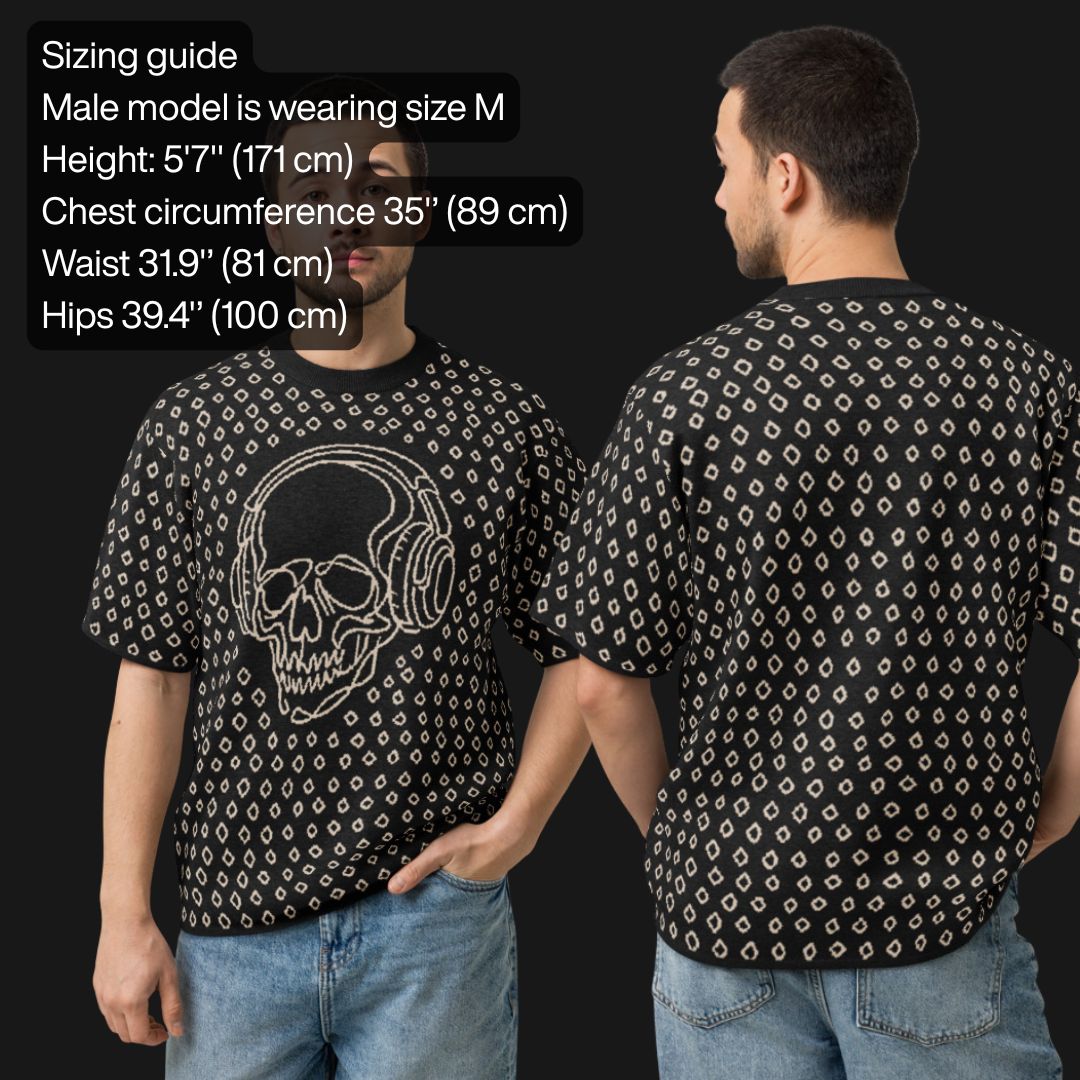 Man wearing a black short sleeve knit featuring a line art skull with headphones and hand drawn diamonds, with sizing information