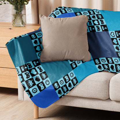 a fleece sherpa blanket with squares and very other square filled with retro pixelated gaming symbols