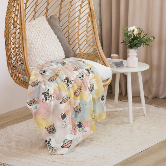 a pastel ice cream colored fleece sherpa blanket with space theme