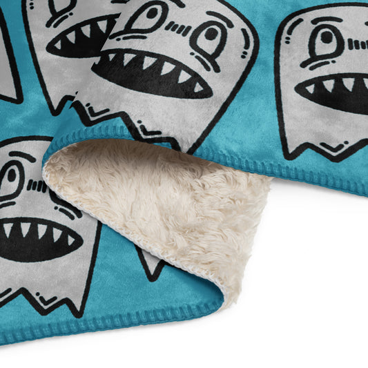 a sky blue fleece sherpa blanket with grinning goblins