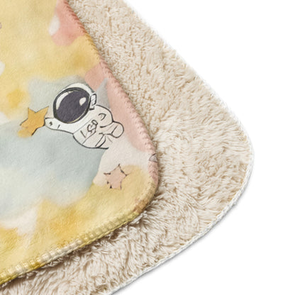 a pastel ice cream colored fleece sherpa blanket with space theme