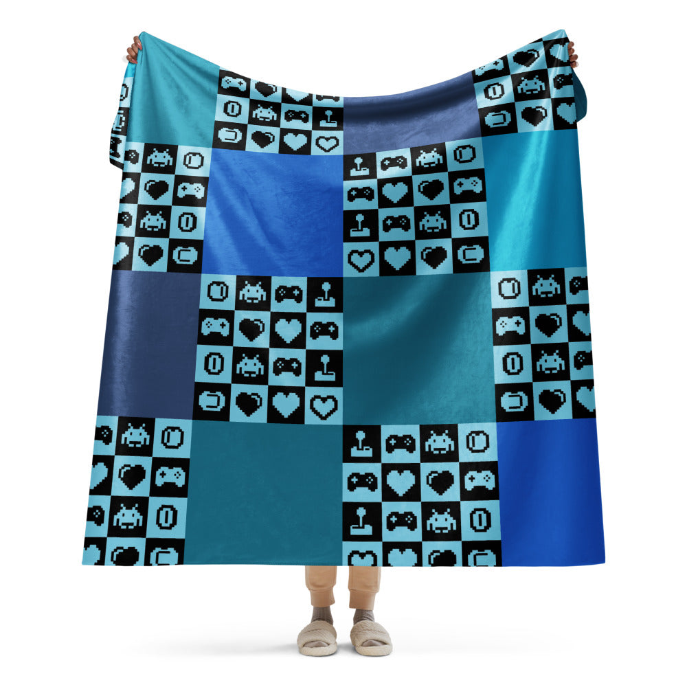a fleece sherpa blanket with squares and very other square filled with retro pixelated gaming symbols