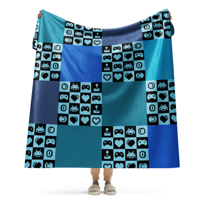 a fleece sherpa blanket with squares and very other square filled with retro pixelated gaming symbols