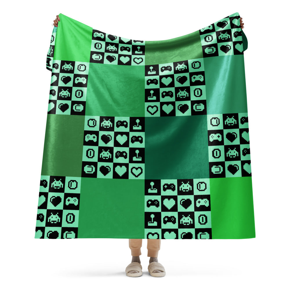 a fleece sherpa blanket with squares and very other square filled with retro pixelated gaming symbols