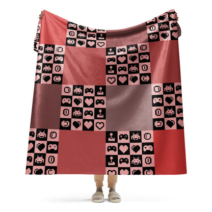 a fleece sherpa blanket with squares and very other square filled with retro pixelated gaming symbols