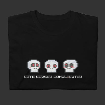 A t-shirt with pixel art skulls and text "cute cursed complicated"