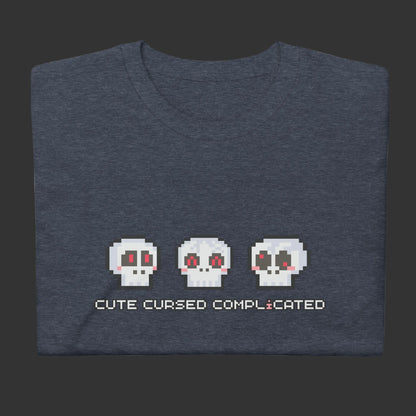 A t-shirt with pixel art skulls and text "cute cursed complicated"