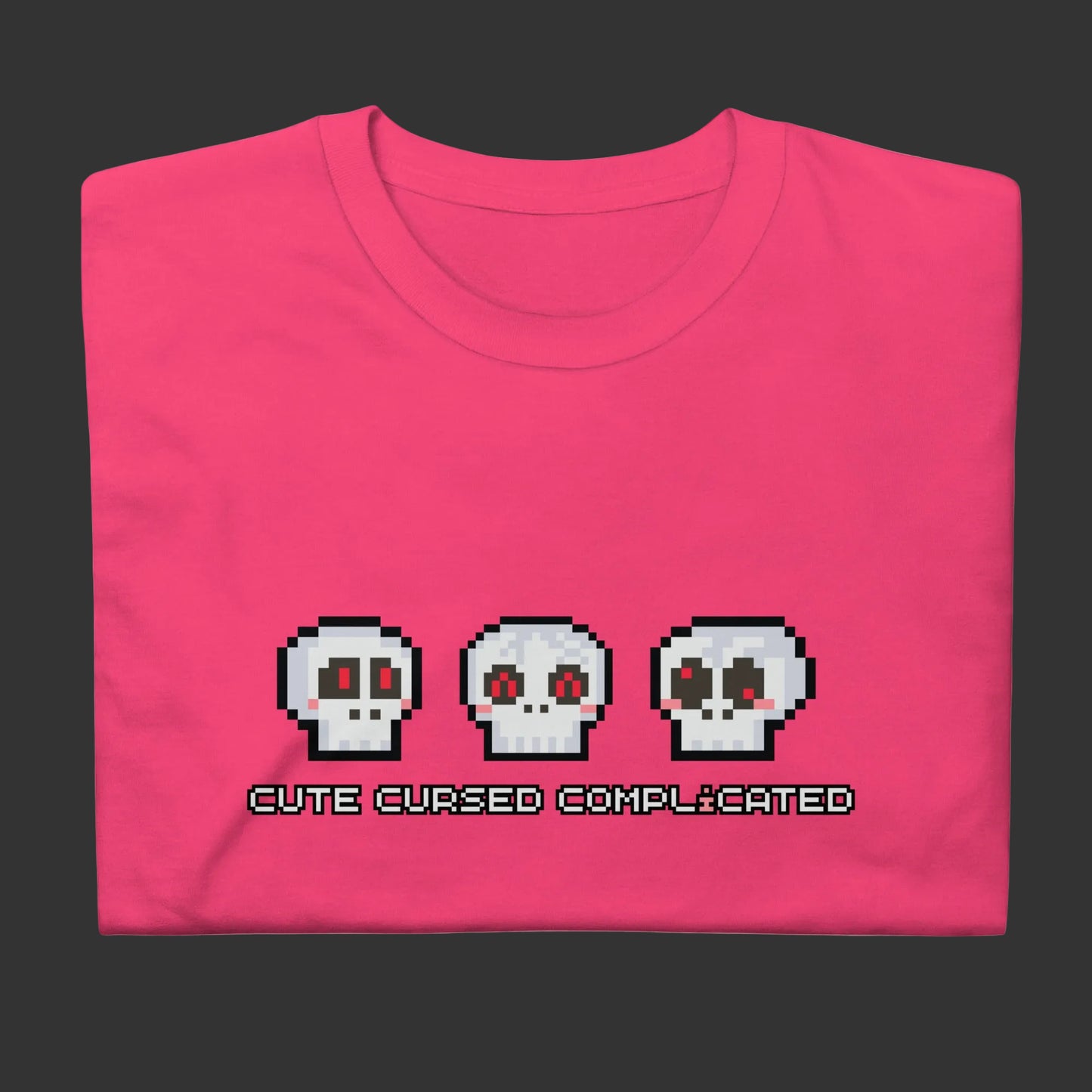 A t-shirt with pixel art skulls and text "cute cursed complicated"