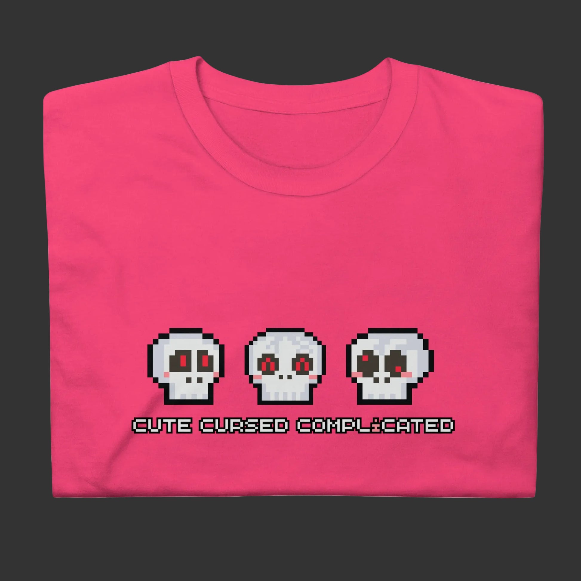 A t-shirt with pixel art skulls and text "cute cursed complicated"