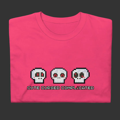 A t-shirt with pixel art skulls and text "cute cursed complicated"