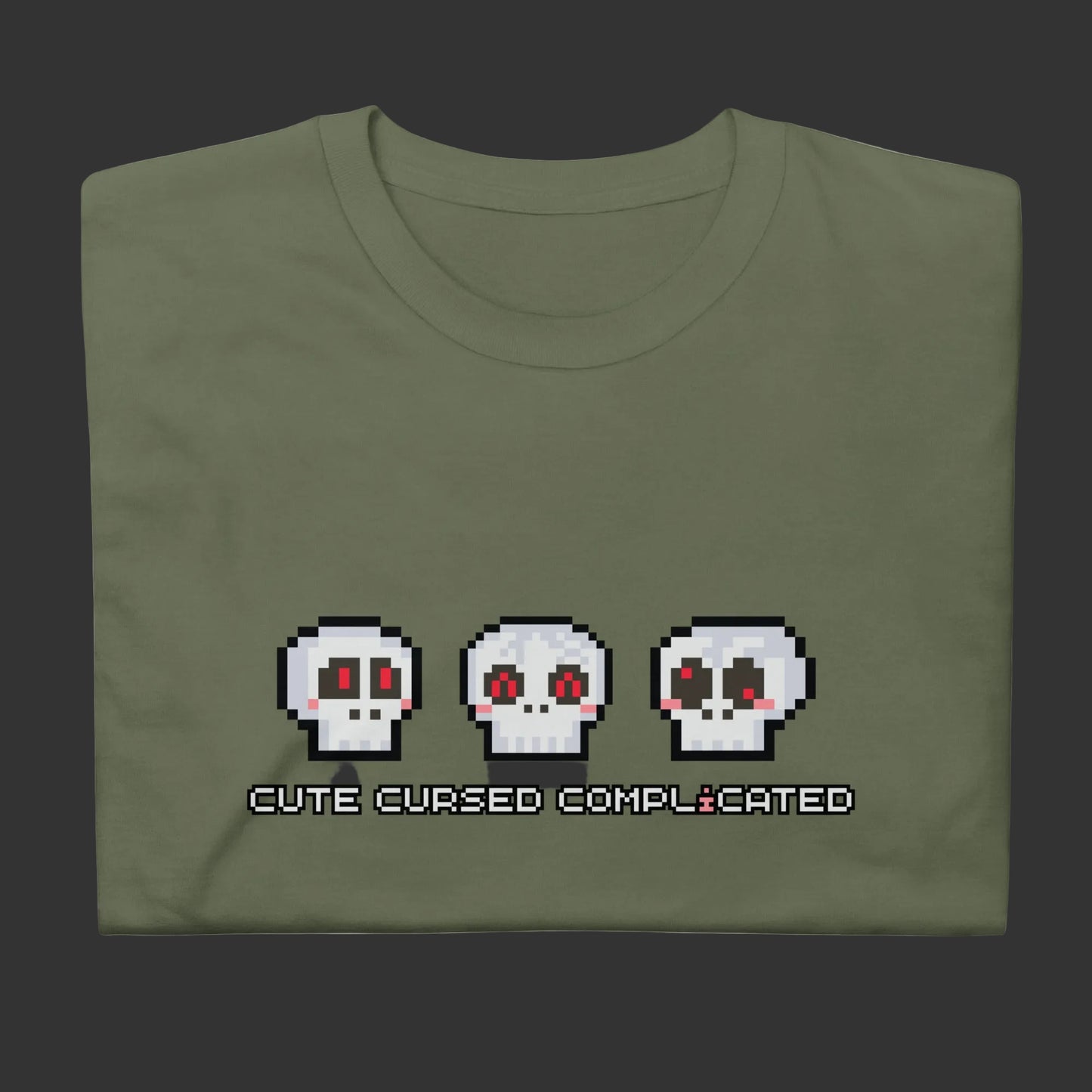 A t-shirt with pixel art skulls and text "cute cursed complicated"