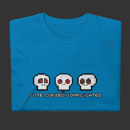 A t-shirt with pixel art skulls and text "cute cursed complicated"