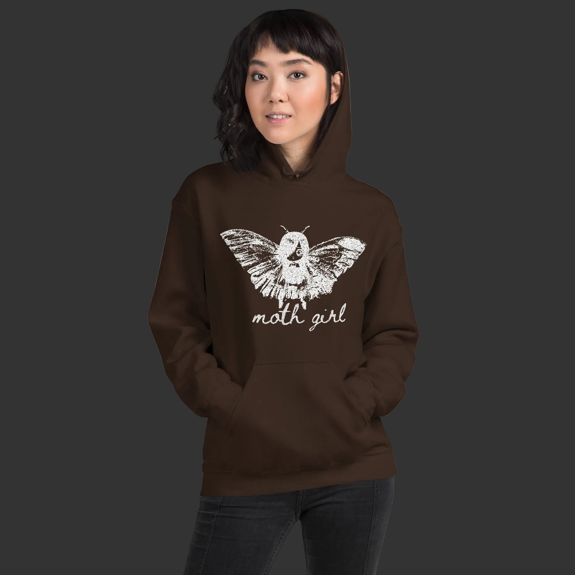 Person wearing a hoodie with a distressed pointillism design of an emo girl with moth wings and the text "moth girl"