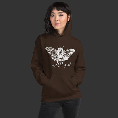 Person wearing a hoodie with a distressed pointillism design of an emo girl with moth wings and the text "moth girl"