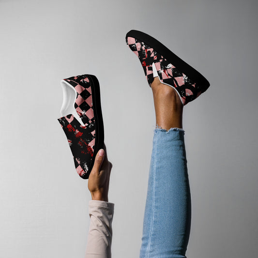 woman wearing slip on shoes with a pink and black distressed checker emo pattern