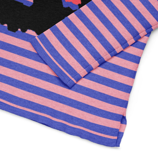 detail of a sweater with pink and blue stripes and an x-eyed black skull design